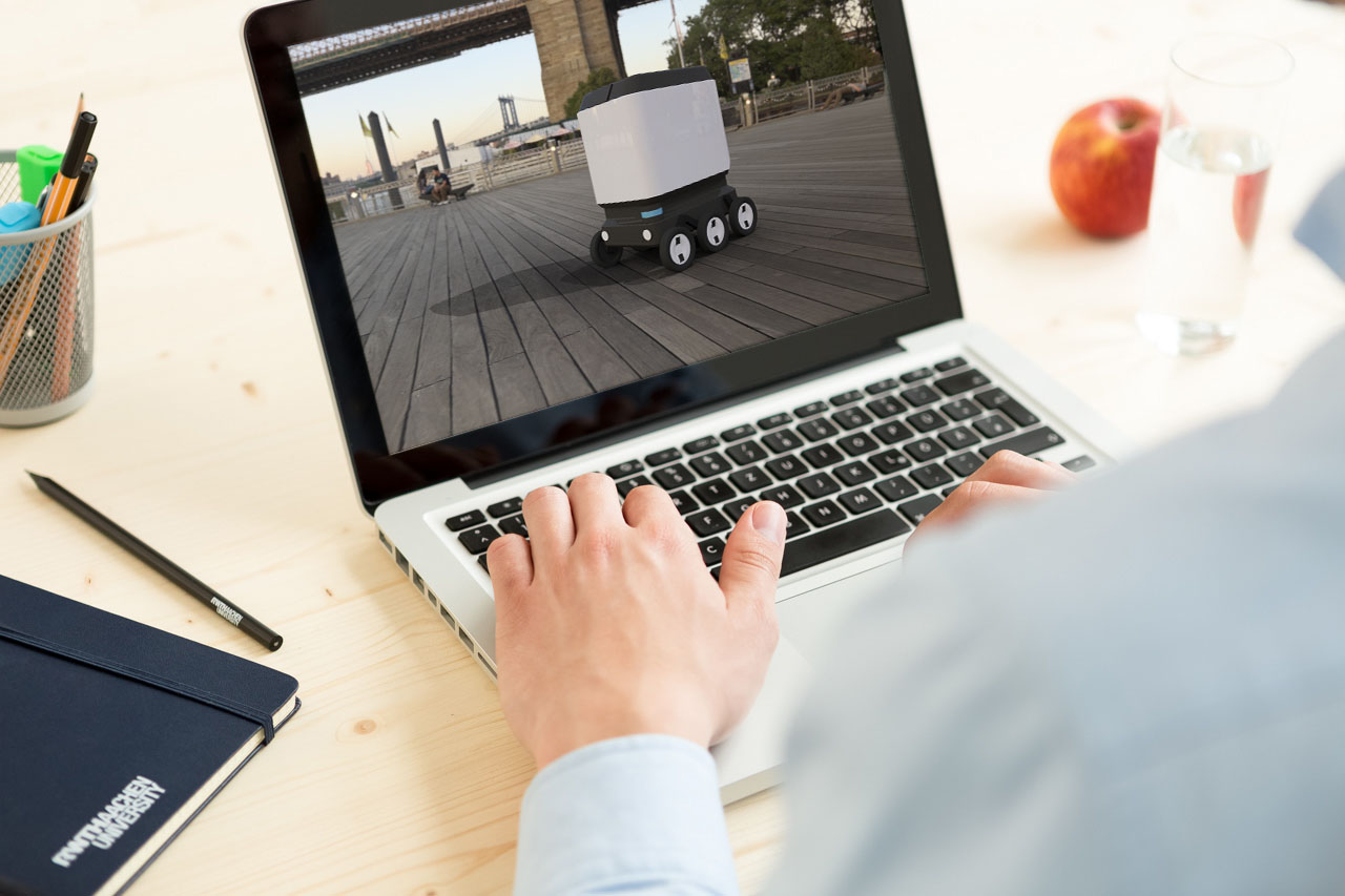 The photo shows a person at a laptop. On the laptop screen you can see the image of a design of the micromobile "Urbant". This is presented in the following article.